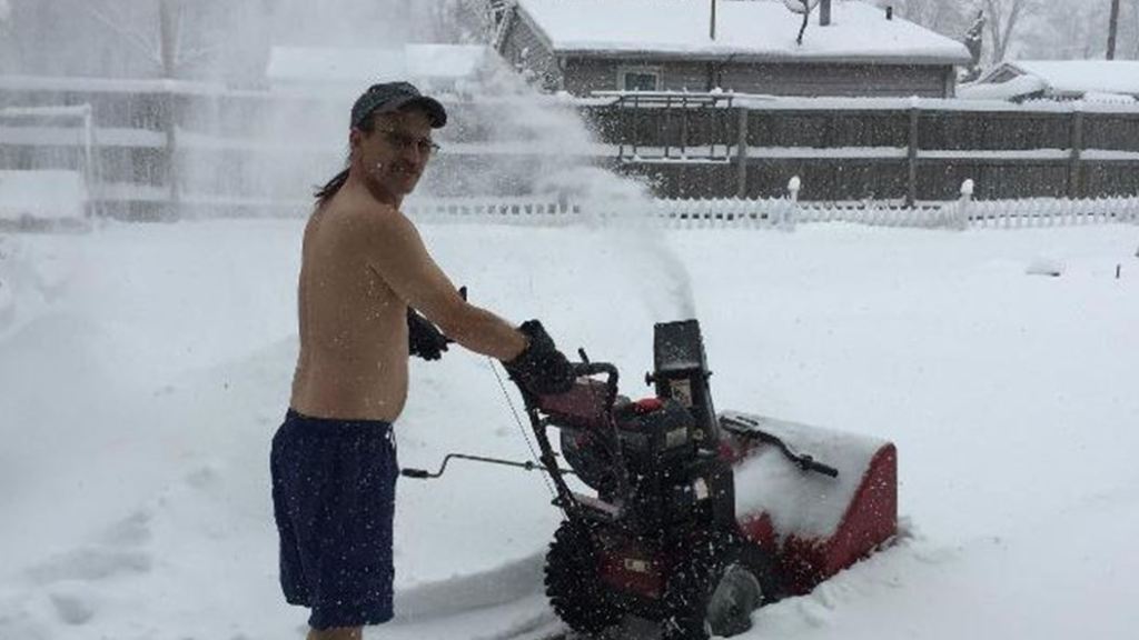 Portage man strips while blowing snow to out do neighbour